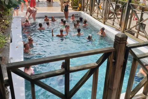 Tourists relaxing in the swimming pool after the Dalyan mud bath experience.